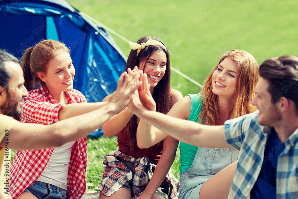 happy friends making high five at camping happy friends making high five at camping