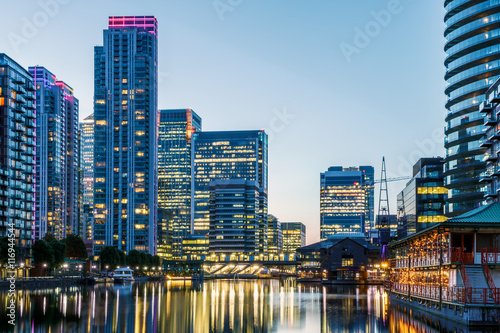 Illuminated buildings in Canary Wharf, London seen from Millwall Dock photo