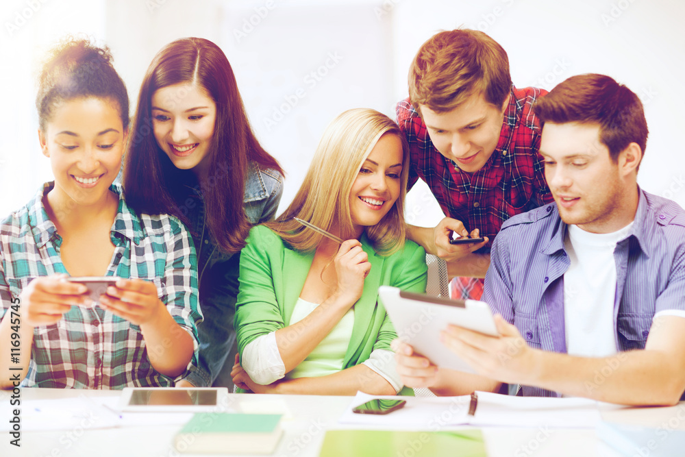 students looking at smartphones and tablet pc students looking at smartphones and tablet pc