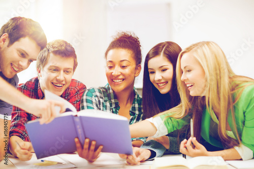 students reading book at school