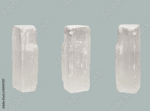 transparent crystal of Selenite isolated on blue background photo