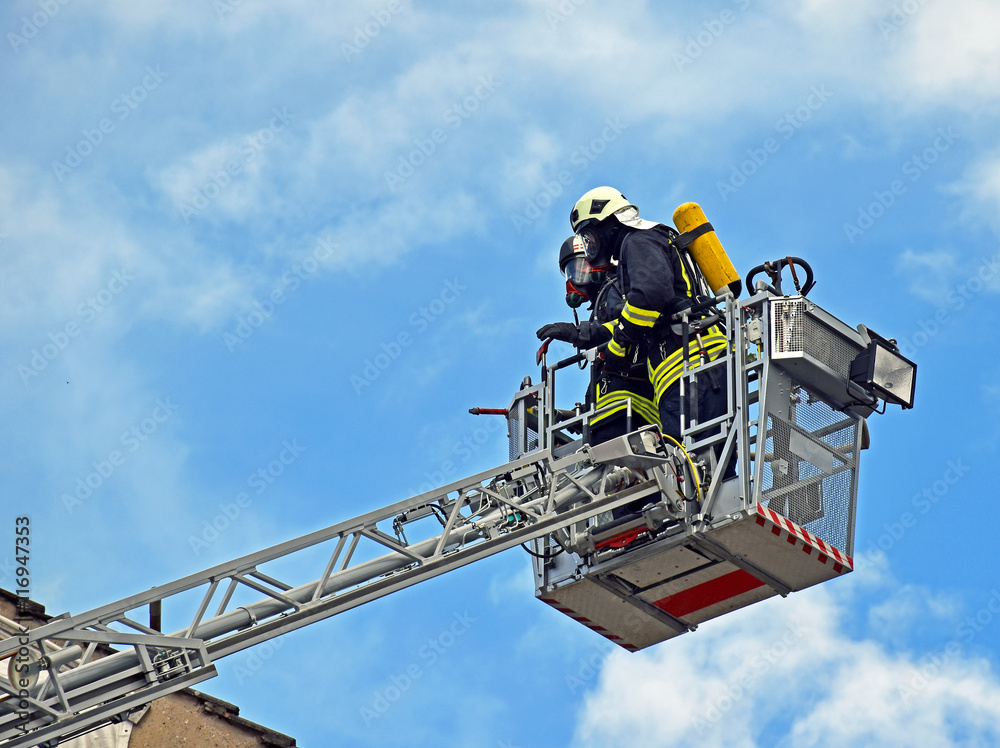 Fototapeta premium Firefighters on a ladder
