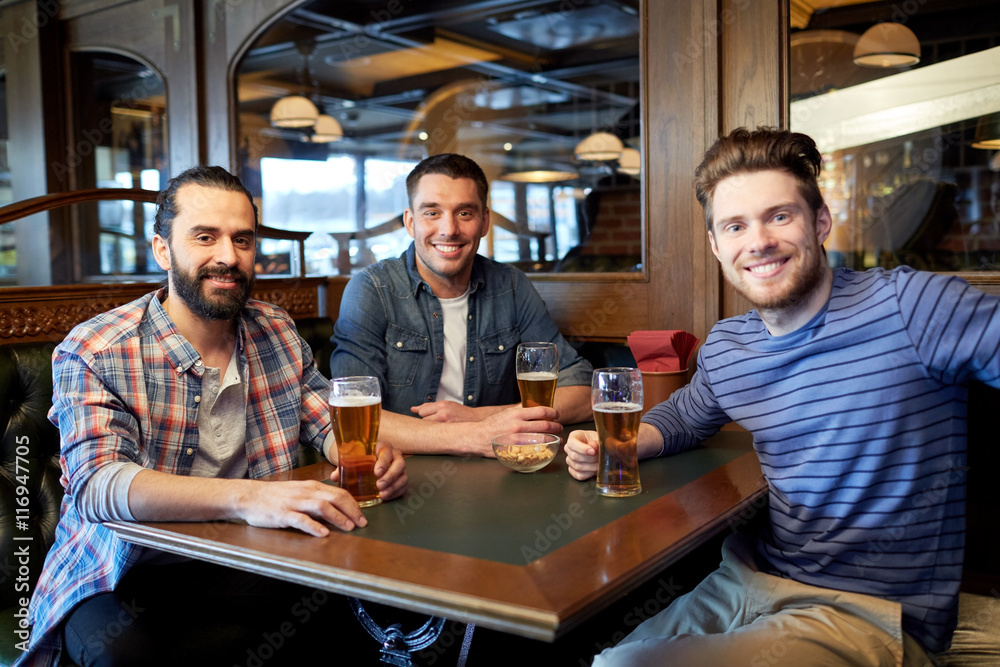 happy male friends drinking beer at bar or pub happy male friends drinking beer at bar or pub