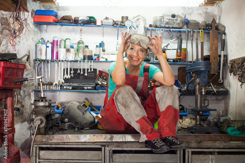 young woman posing in a mechanic shop