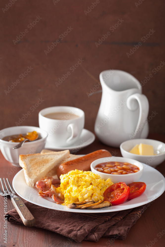 full english breakfast with scrambled eggs, bacon, sausage, bean