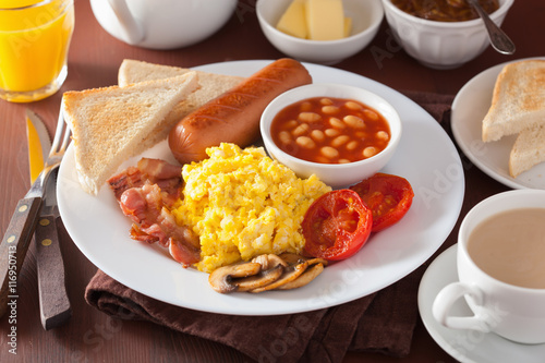 full english breakfast with scrambled eggs, bacon, sausage, bean