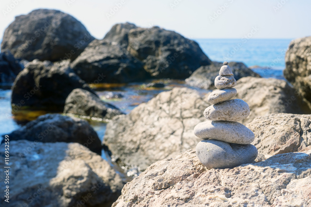 Small pyramid is among the large stones near the Black sea. Small pyramid is among the large stones near the Black sea.