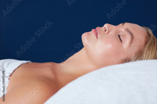 Attractive young woman relaxing on massage table