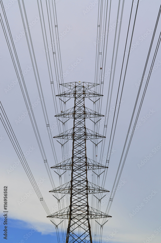 Pylon with power lines against cloudy sky Pylon with power lines against cloudy sky