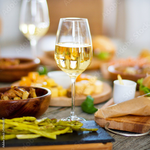 Wine, grape and cheese on wooden table