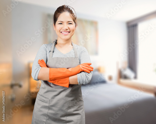 Obraz na plátně asian housewife wearing rubber gloves crossed arms