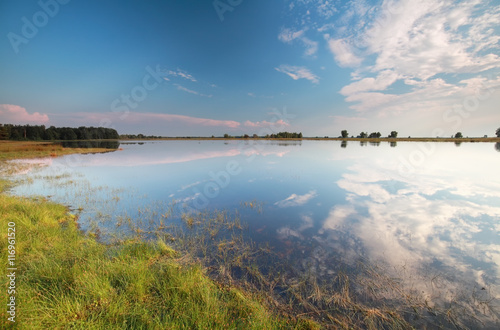 blue sky reflected in wild lake photo