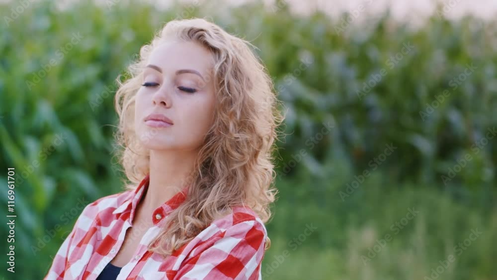 Portrait of an attractive woman farmer, looking into the camera, smiling Portrait of an attractive woman farmer, looking into the camera, smiling