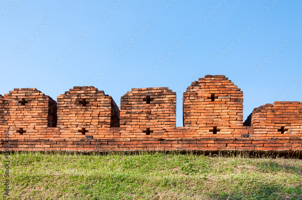 A portion of the ancient fortified city wall built of brick with cross bow cutouts and crenelations, Chiang Mai, Thailand ,Image of Fortress