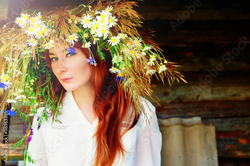 beautiful happy girl in a flower wreath photo