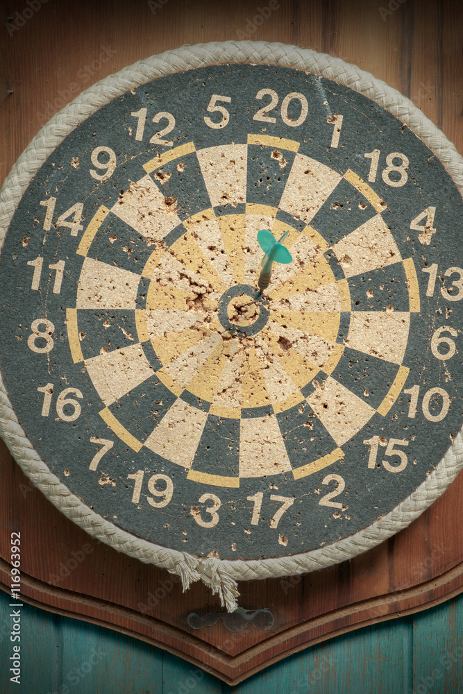 Fototapeta premium Old dartboard / Close up old dartboard on old wood background. Top view.