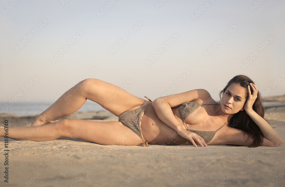 Beautiful woman sunbathing at the beach