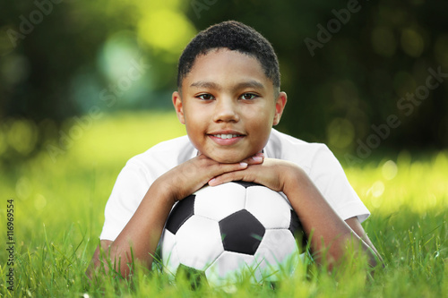African American boy with soccer ball in park © Africa Studio