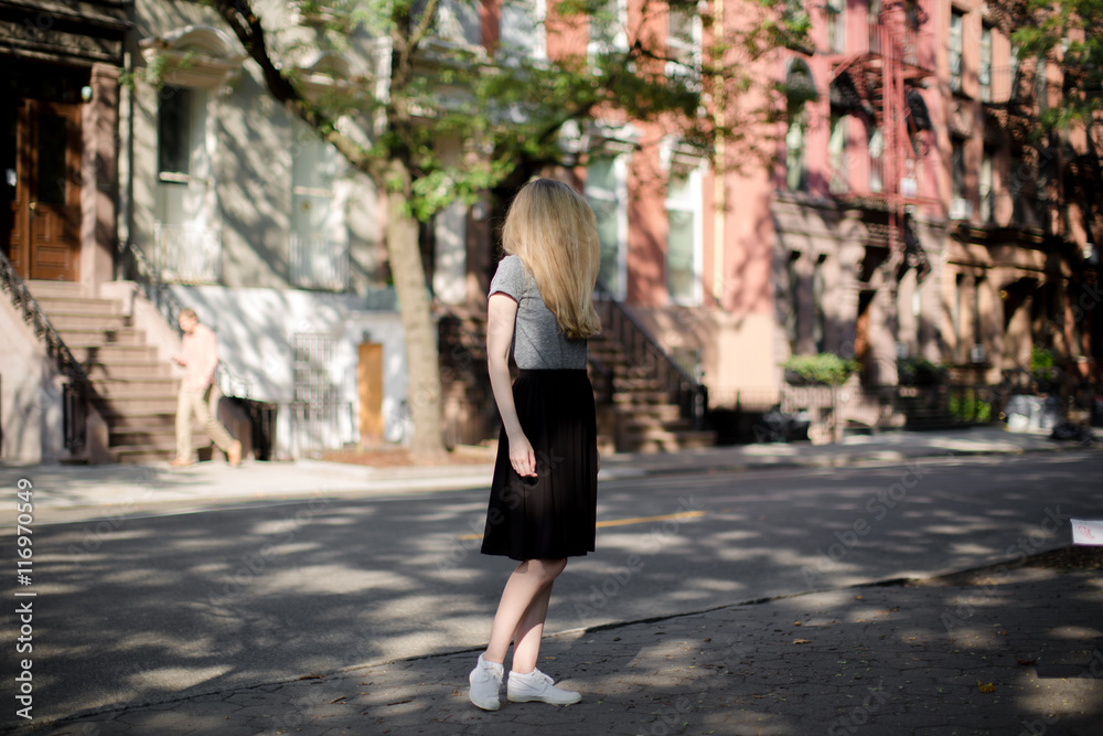 Young lady looking down the street