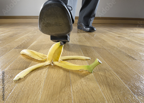 Man about to step on banana peel close up. 