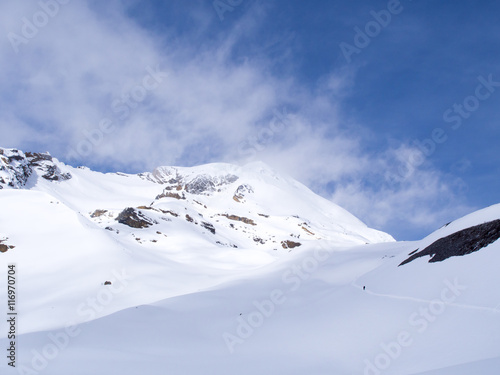 Pathway crossing the snow mountain with overcast weather sky, Thorong La Pass, Annapurna Conservation Area, Nepal © lighthunter