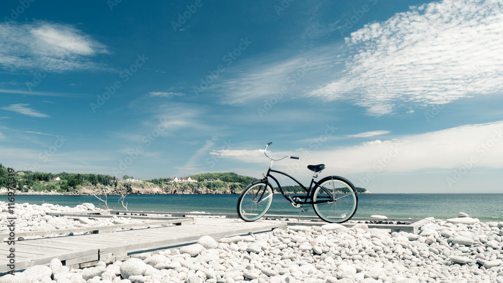 Fototapeta premium Beach bike on stony beach at Gulf of St. Lawrence
