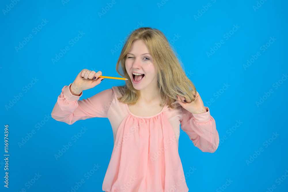 fun playful blonde girl winks with a pencil in hand fun playful blonde girl winks with a pencil in hand