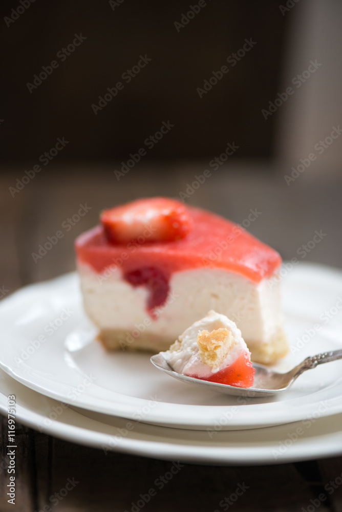 Homebaked Summer Berry Cheesecake with Jelly on the Top made from Raspberries and Strawberries on White Plates Homebaked Summer Berry Cheesecake with Jelly on the Top made from Raspberries and Strawberries on White Plates