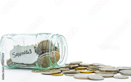 Savings jar on it's side with coins spilling out