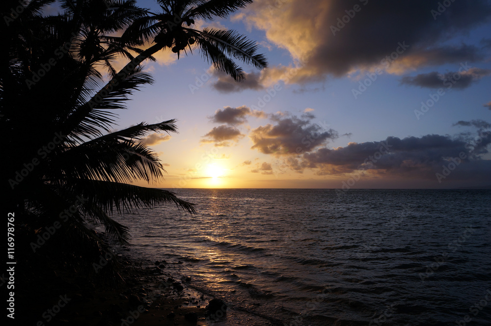 Beautiful Sunrise over the ocean with waves moving to rocky Beac