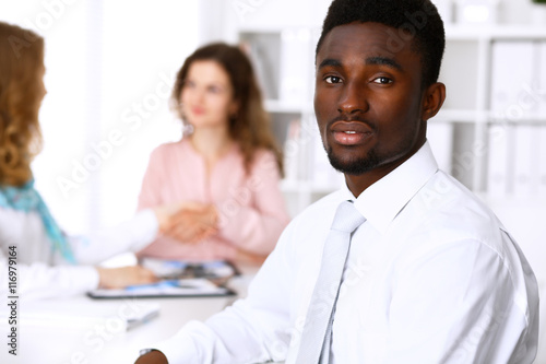 African american businessman at meeting in white colored office background