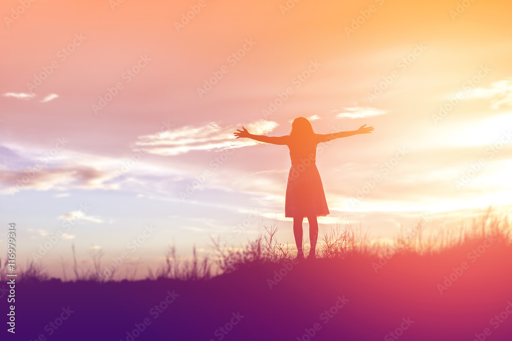 Silhouette of woman praying over beautiful sky background Silhouette of woman praying over beautiful sky background