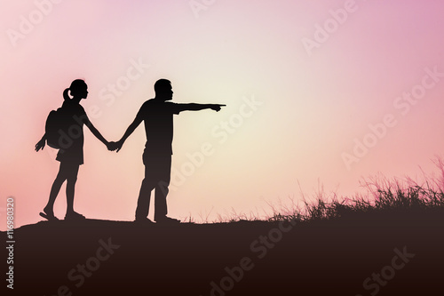 a silhouette of a man and woman holding hands with each other