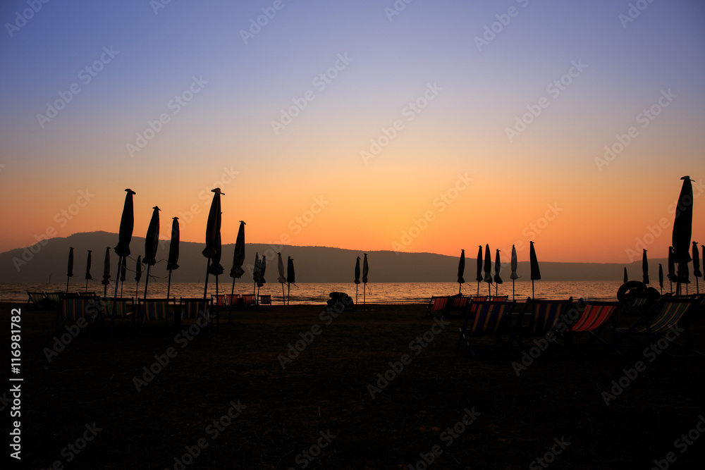 Beach Umbrella on Beach beautiful evening sky light and shadow Beach Umbrella on Beach beautiful evening sky light and shadow