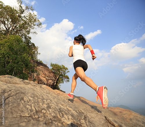 young asian woman runner running on mountain peak © lzf