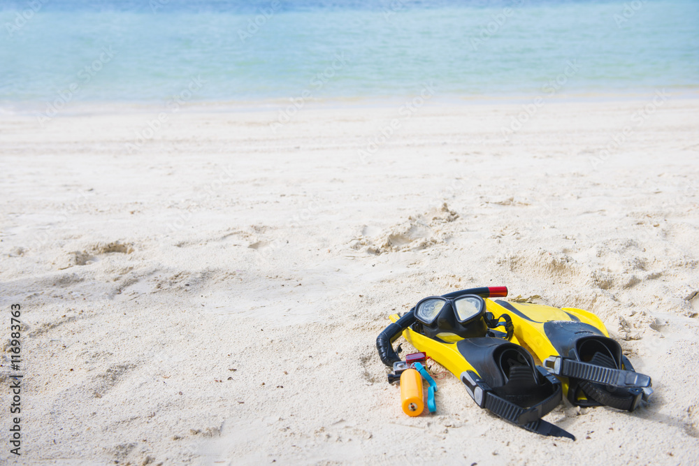 Fins, diving masks and camera for underwater on the beach Fins, diving masks and camera for underwater on the beach