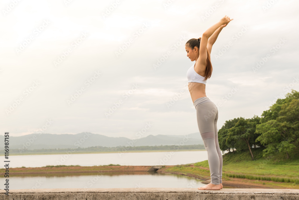 Fototapeta premium Young sportswoman stretching