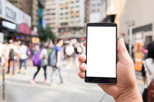 Close up of a man using smart phone with blank mobile and cup of coffee .Smart phone with blank screen and can be add your texts or others on smart phone.