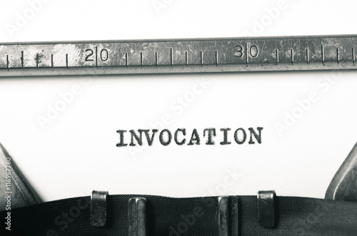 фотографія word invocation typed on typewriter