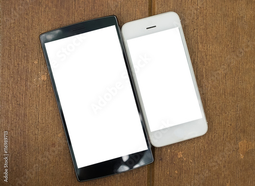 two blank mobile on wooden desk .Smart phone with blank screen a