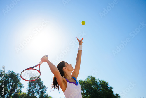 Young woman playing tennis. © dangutu