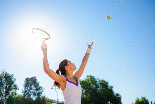 Young woman playing tennis. © dangutu