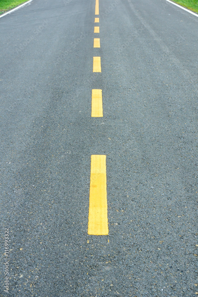 asphalt texture with yellow dashed line.