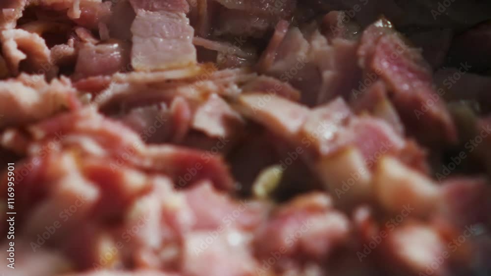 frying bacon on a pan for carbonara close up frying bacon on a pan for carbonara close up