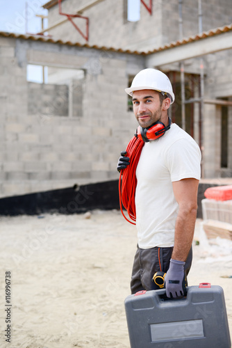portrait of handsome construction worker on a building industry construction site