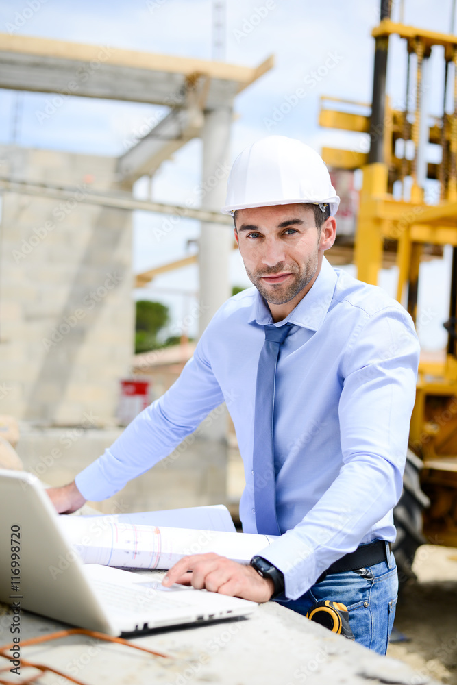 portrait of handsome young man architect on a building industry construction site portrait of handsome young man architect on a building industry construction site