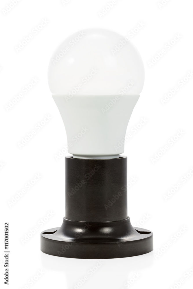 Economical LED bulb is inserted in a black ceramic electric holder isolated on white background Economical LED bulb is inserted in a black ceramic electric holder isolated on white background