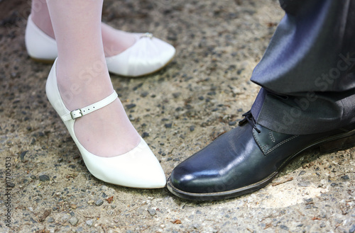 Leg and shoes of wedding couple outdoor