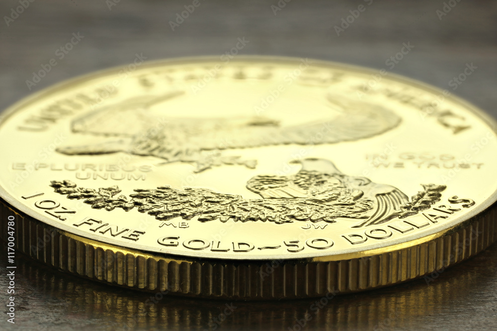 1 ounce American gold eagle bullion coin on wooden background 1 ounce American gold eagle bullion coin on wooden background