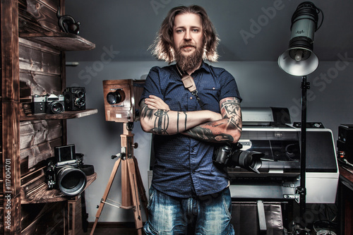 Beautiful portrait of the photographer at the workplace. The concept of the creative process, skill and favorite pastime